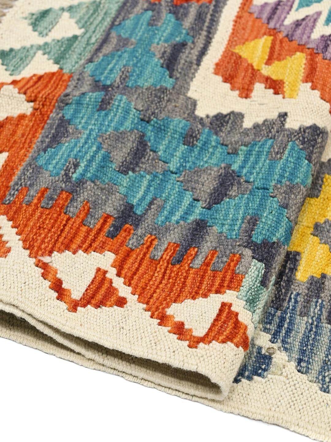 Hand-woven Afghan Kelim rug featuring a multicolor geometric pattern