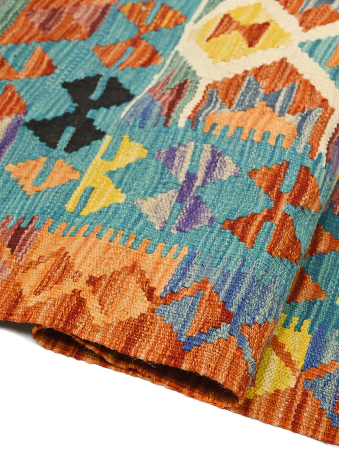 Hand-woven Afghan Kelim rug featuring a vibrant multicolor geometric pattern