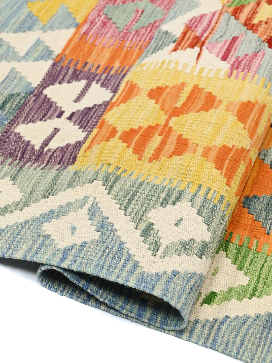 Hand-woven Afghan Kelim rug with a colourful geometric pattern in a rectangular shape.