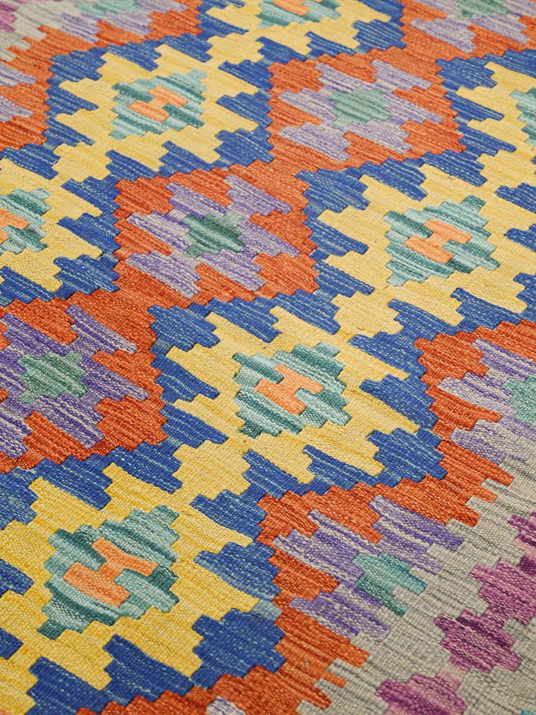 Hand-woven Afghan Kelim rug with vibrant geometric patterns in multicolor Wool