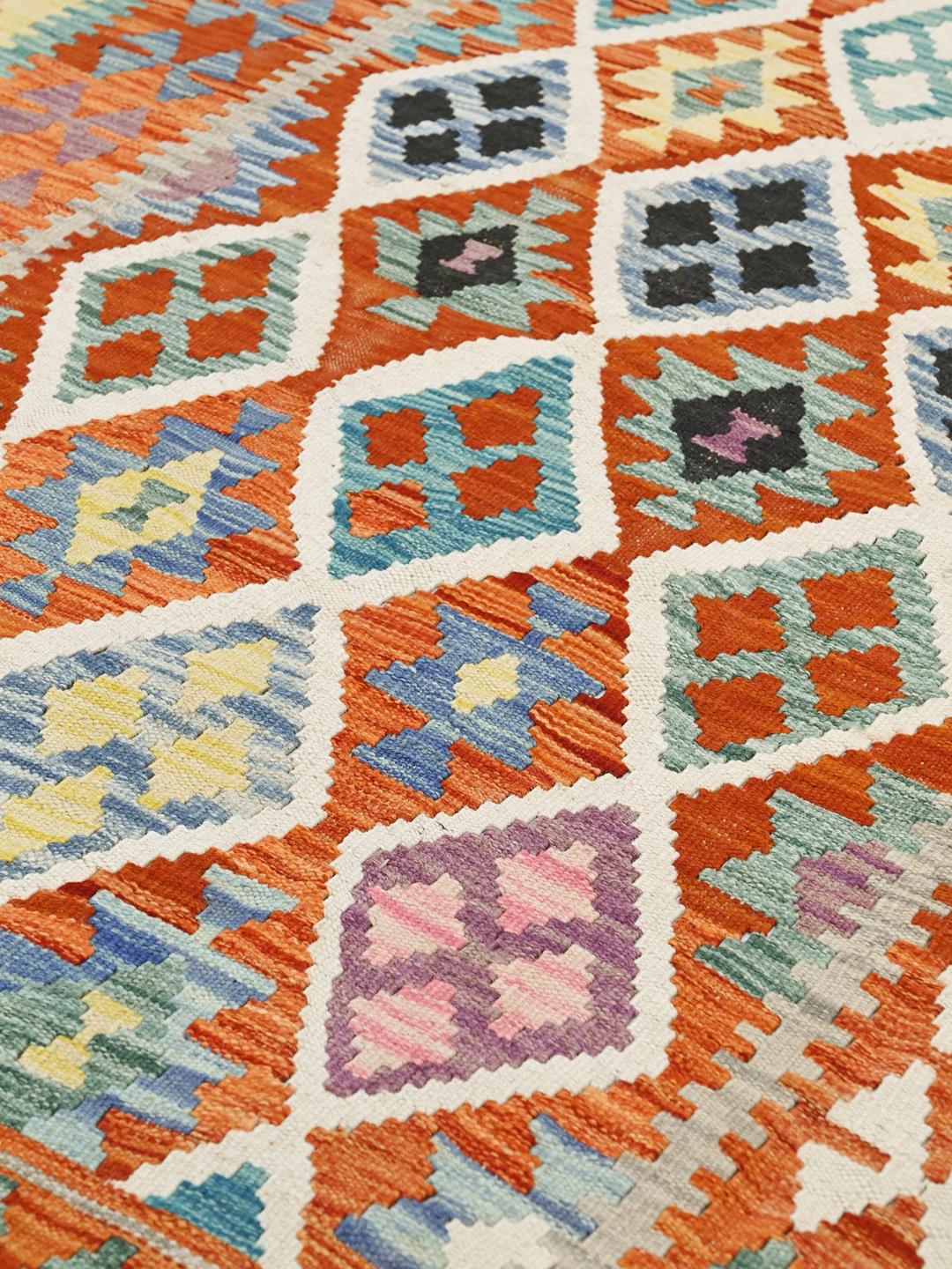 Hand-woven Afghan Kelim rug featuring a vibrant multicolor geometric pattern