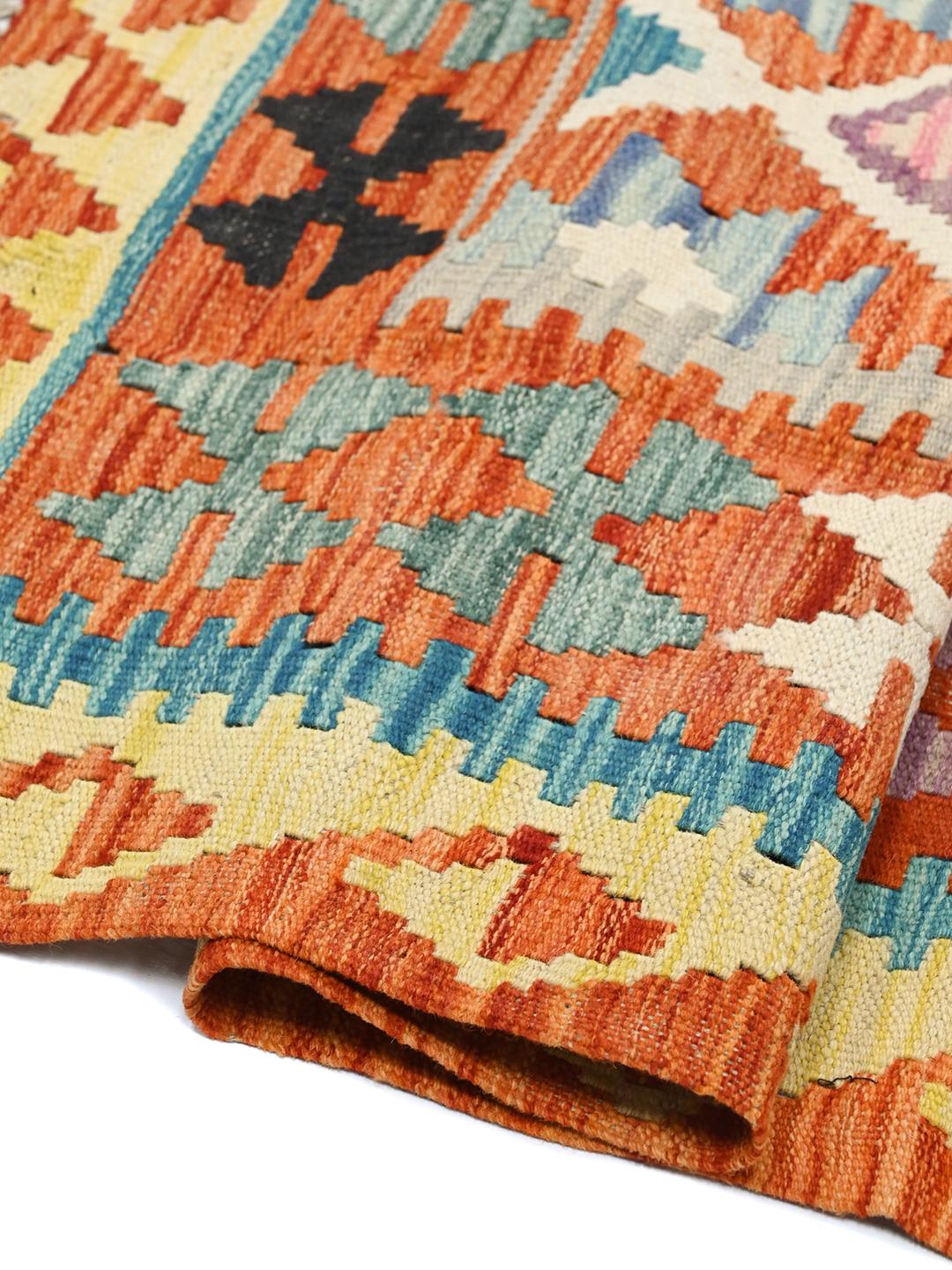 Hand-woven Afghan Kelim rug featuring a vibrant multicolor geometric pattern