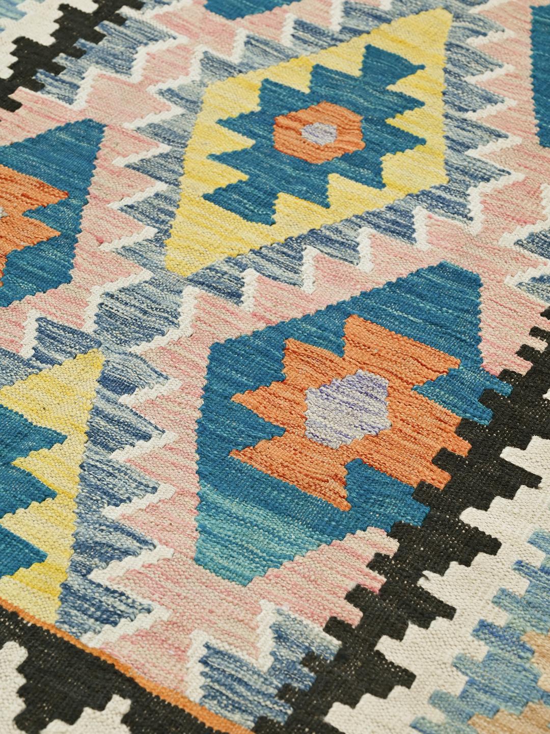 A vibrant Afghan Kelim rug with geometric patterns in blue, orange, and yellow
