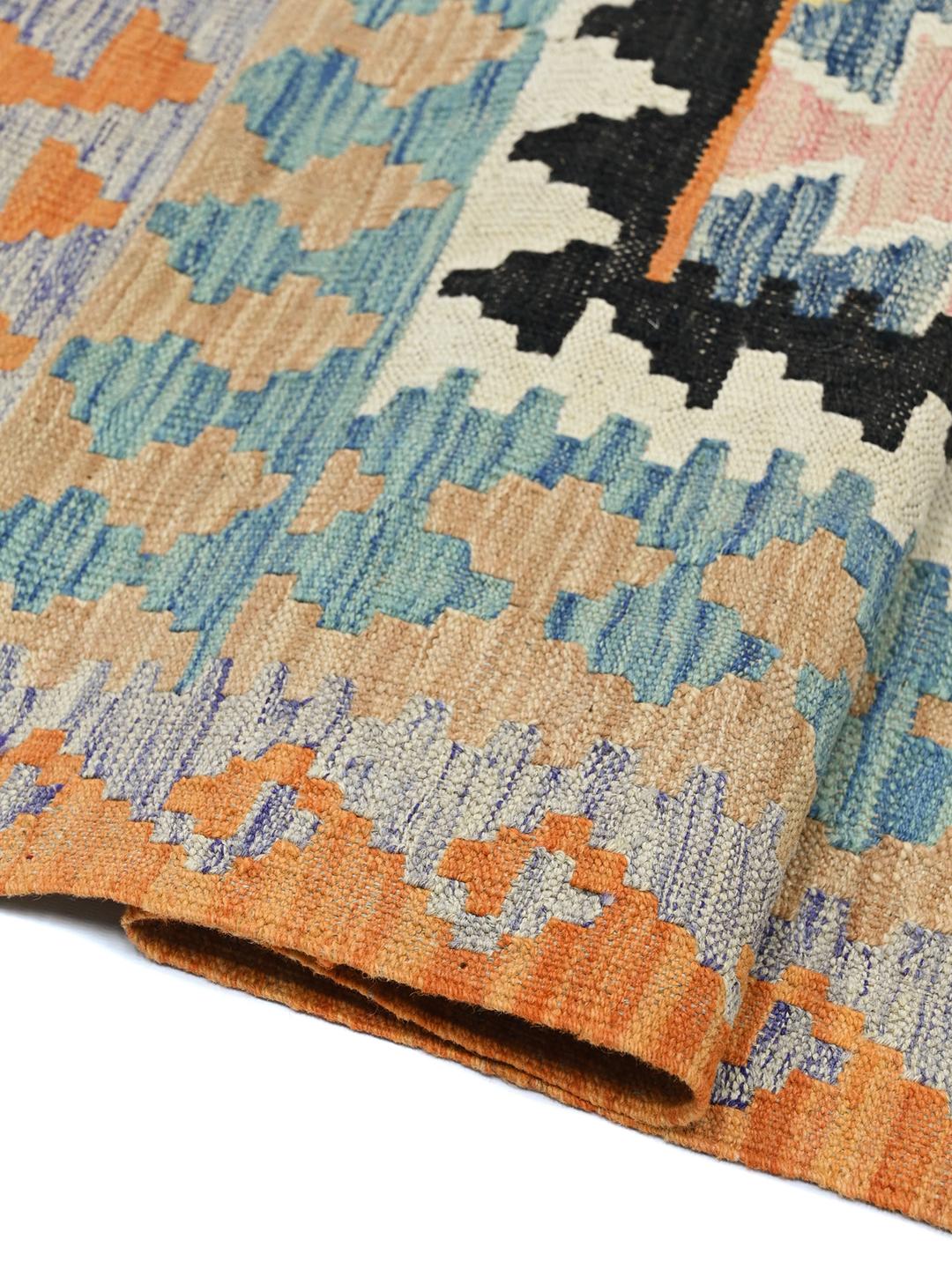 A vibrant Afghan Kelim rug with geometric patterns in blue, orange, and yellow