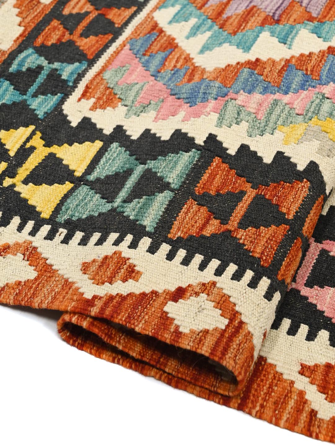 Hand-woven Afghan Kelim rug featuring a colourful geometric design with diamond motifs