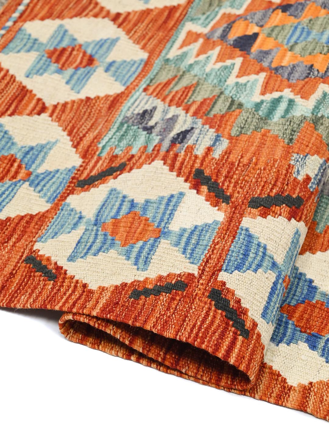 Hand-woven Afghan Kelim rug with geometric diamond patterns in orange and blue