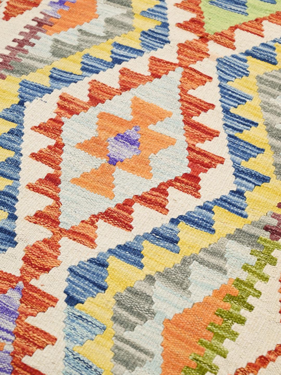 Hand-woven Afghan runner featuring vibrant geometric patterns in a multicolor palette