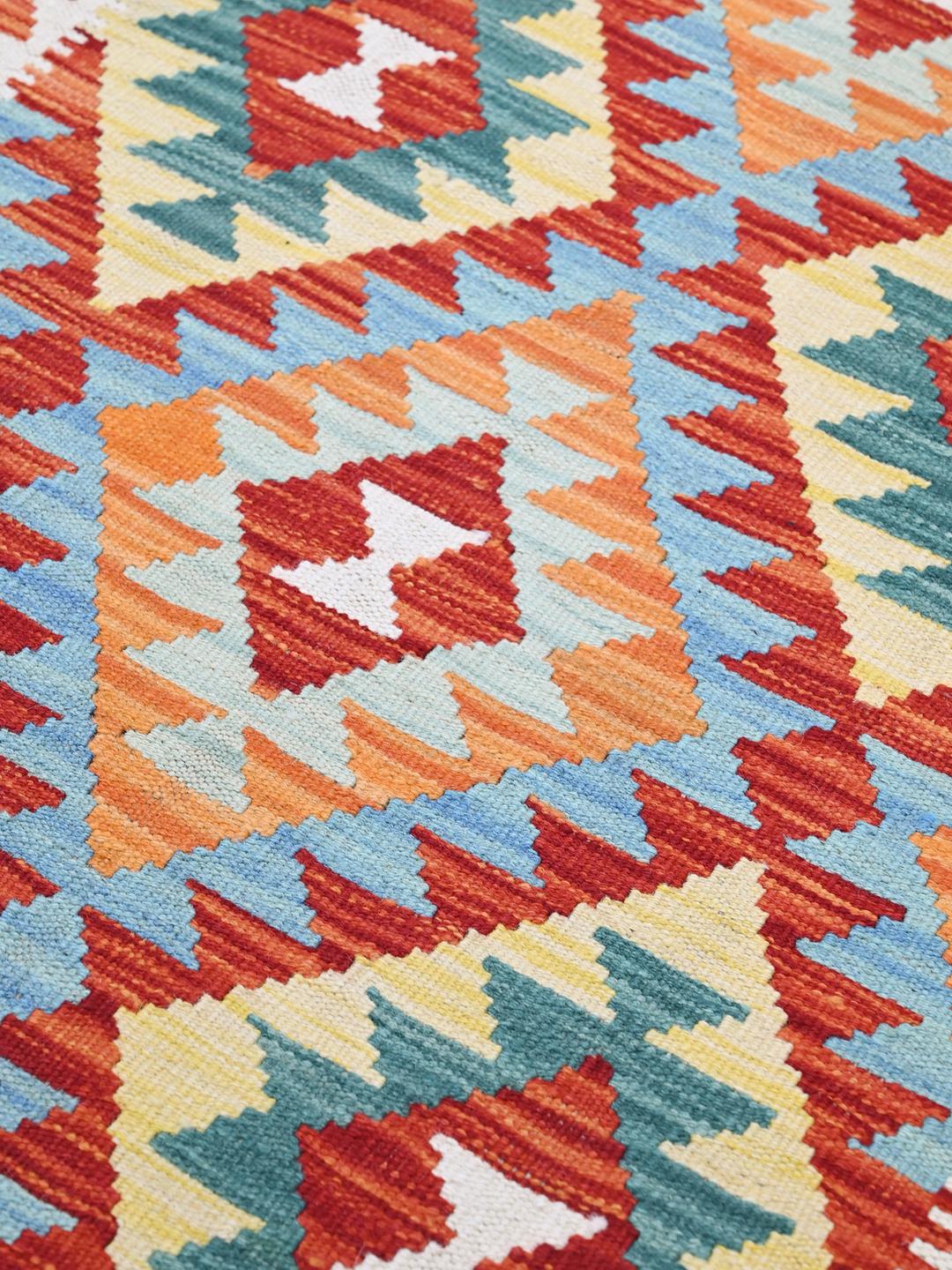 Hand-woven Afghan runner with vibrant geometric diamond motifs in multicolor Wool.
