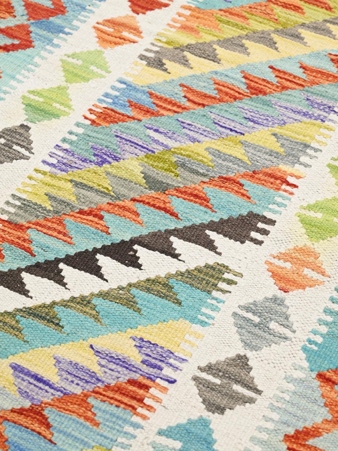 Hand-woven Afghan Kelim runner with vibrant geometric patterns in multicolor wool
