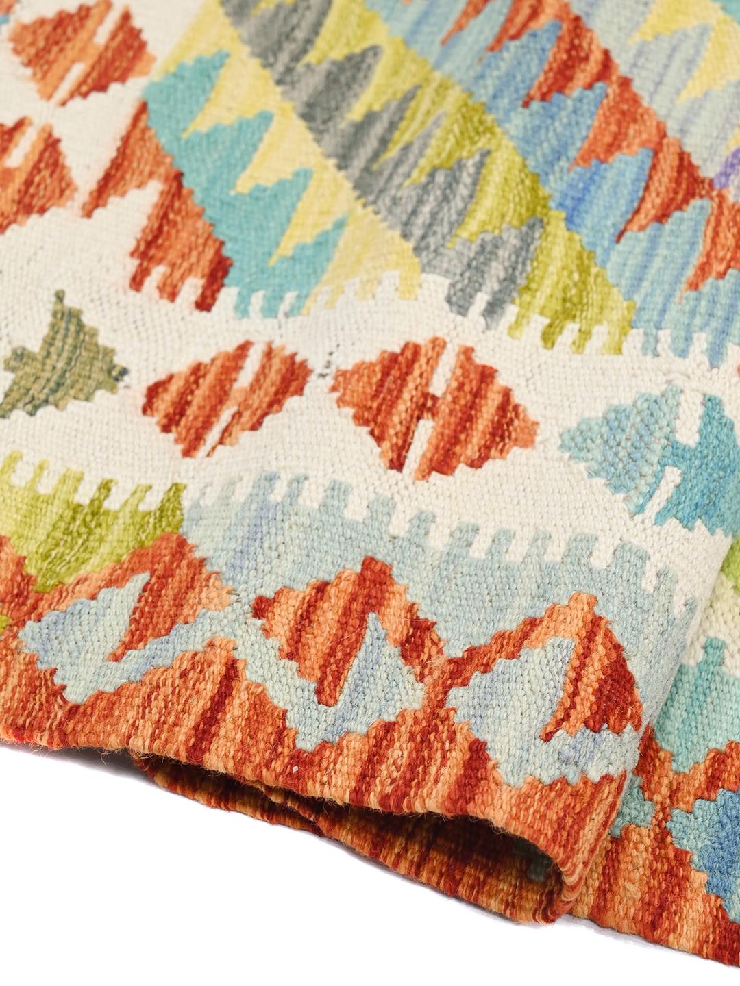 Hand-woven Afghan Kelim runner with vibrant geometric patterns in multicolor wool