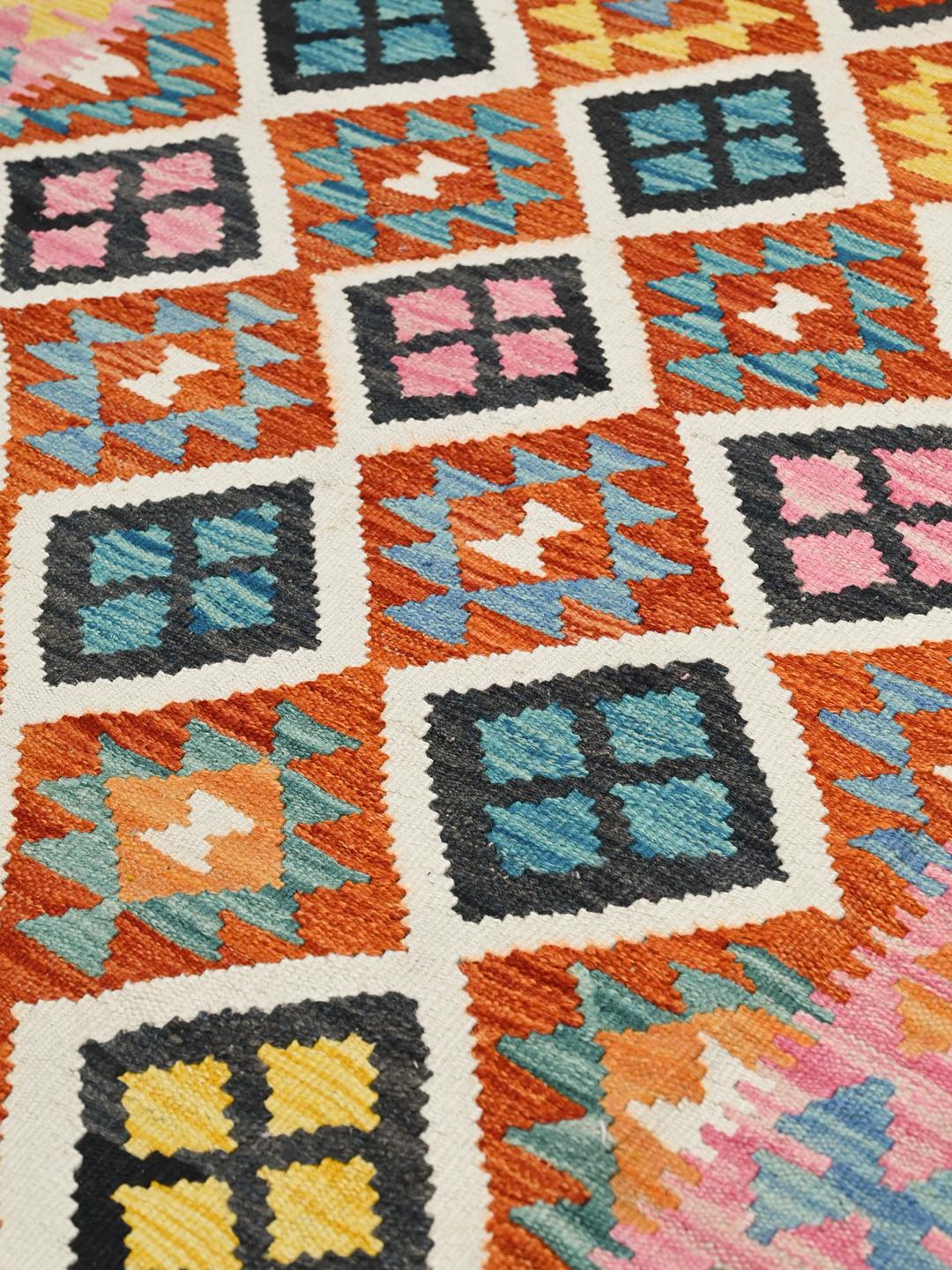 Hand-woven Afghan Kelim rug with a vibrant multicolor geometric diamond pattern
