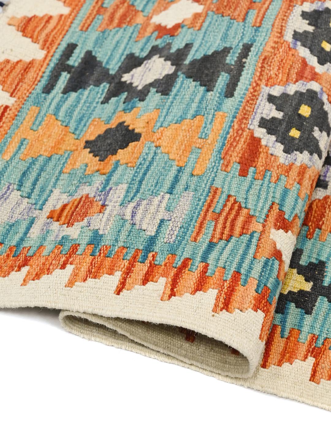 Hand-woven Afghan Kelim rug with vibrant geometric patterns and a multicolor palette