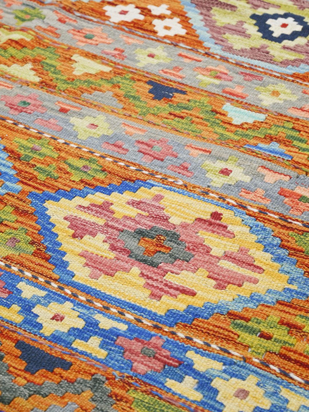 Hand-woven Afghan Kelim rug featuring vibrant geometric patterns in multicolor Wool