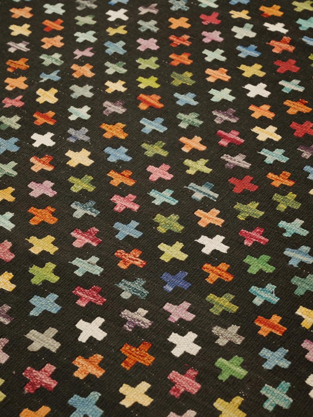 Hand-woven Afghan Kelim rug with a black field and colourful cross motifs