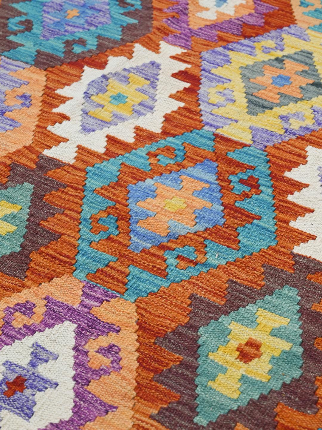 Hand-woven Afghan Kelim rug with vibrant multicolor diamond patterns