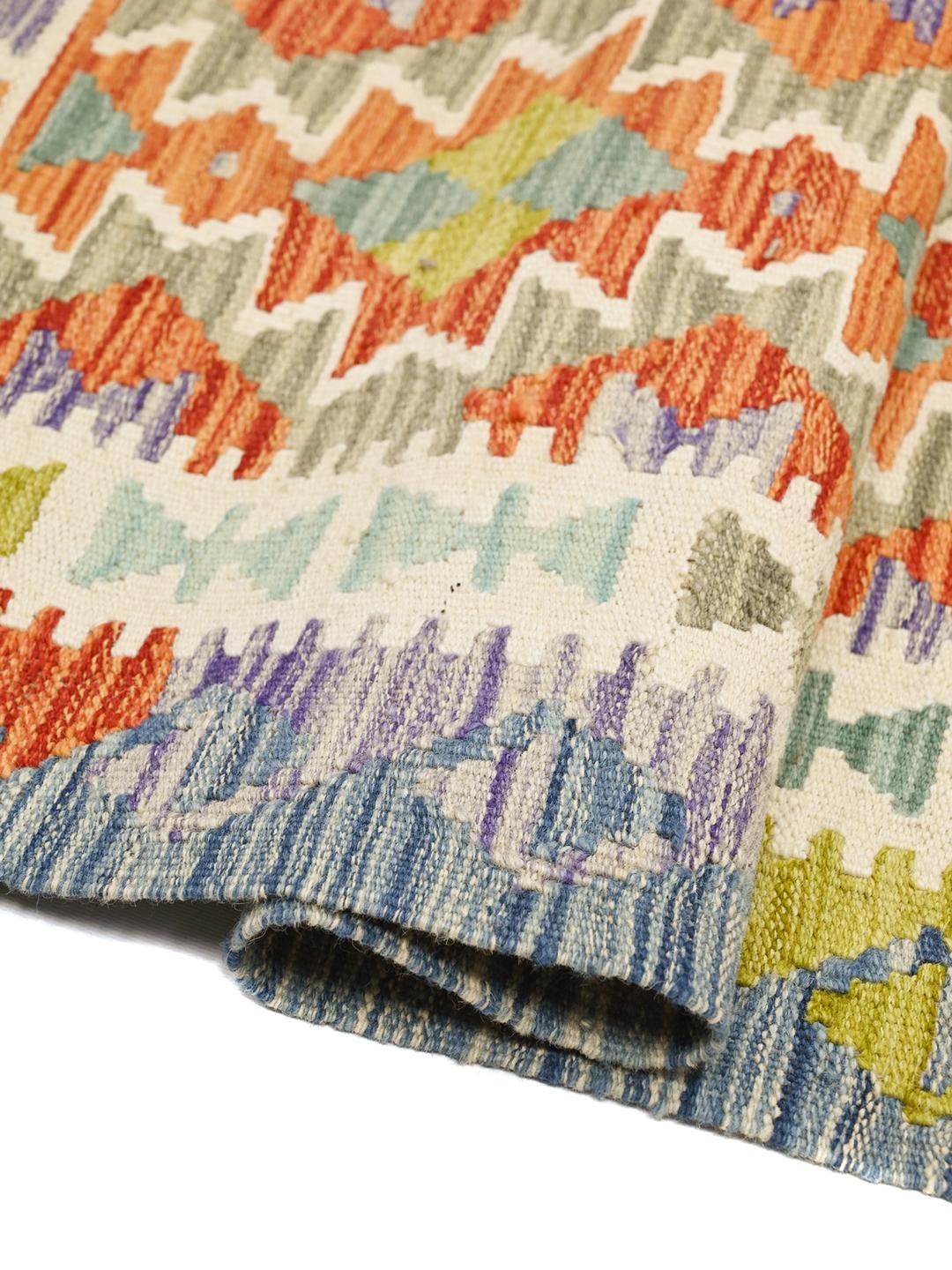 Hand-woven Afghan runner featuring vibrant geometric patterns in multicolor wool.