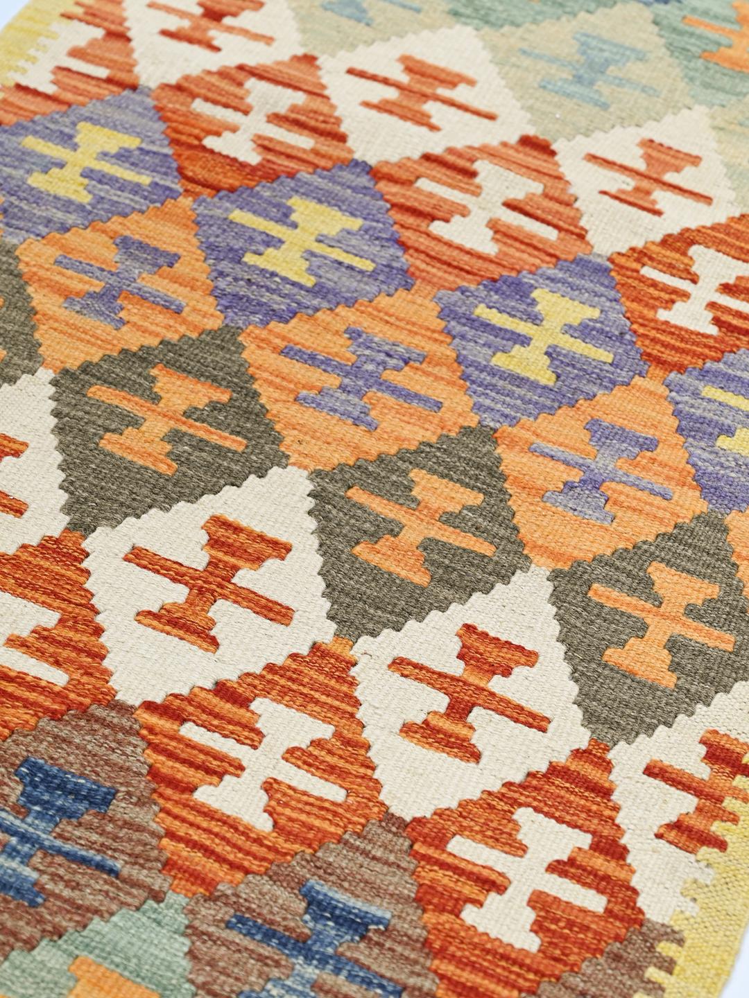 Hand-woven Afghan runner with colourful geometric diamond patterns