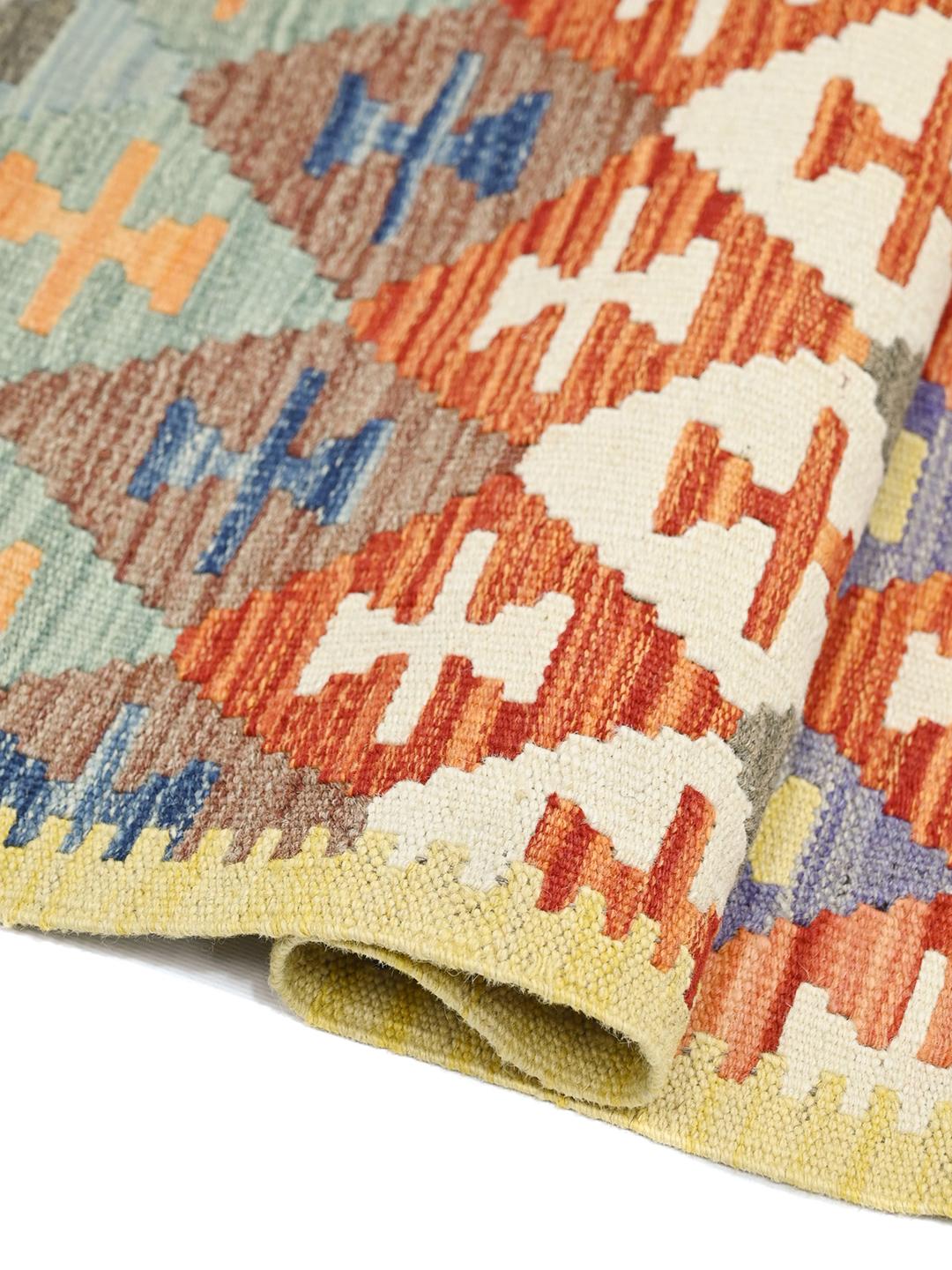 Hand-woven Afghan runner with colourful geometric diamond patterns