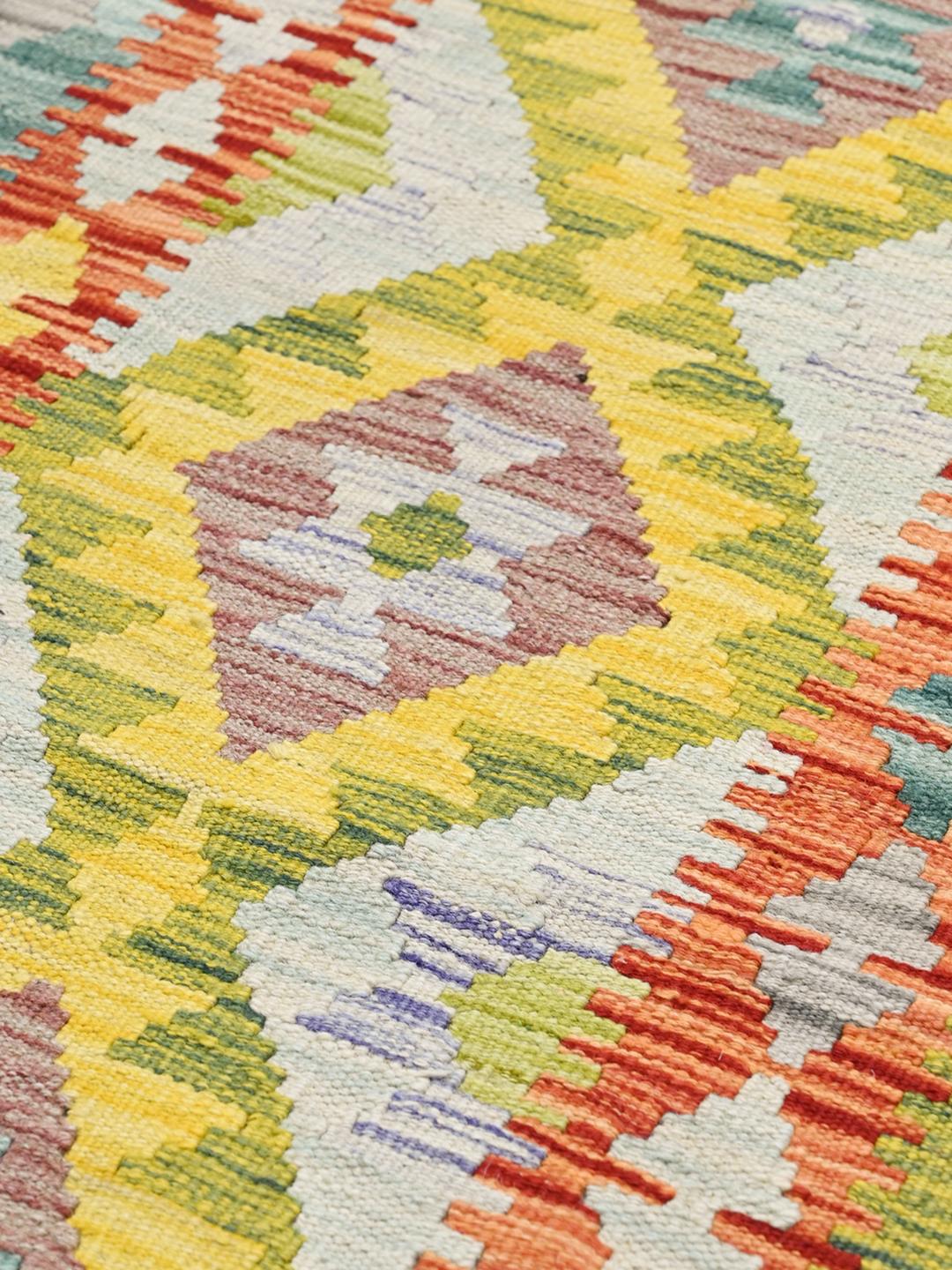 Hand-woven Afghan runner with vibrant geometric diamond patterns in multicolour wool