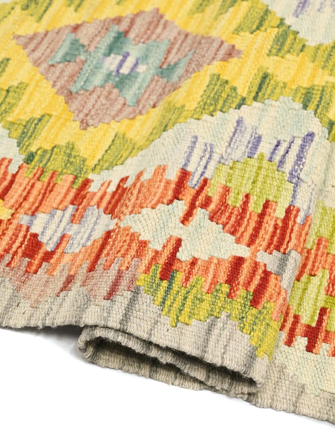 Hand-woven Afghan runner with vibrant geometric diamond patterns in multicolour wool