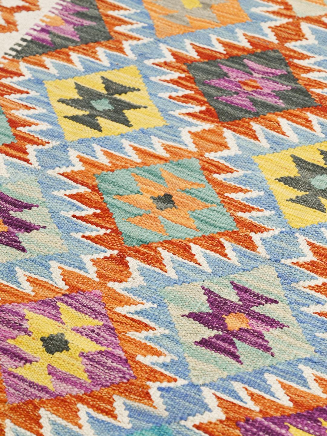 Hand-woven Afghan runner with vibrant geometric patterns in multicolor wool
