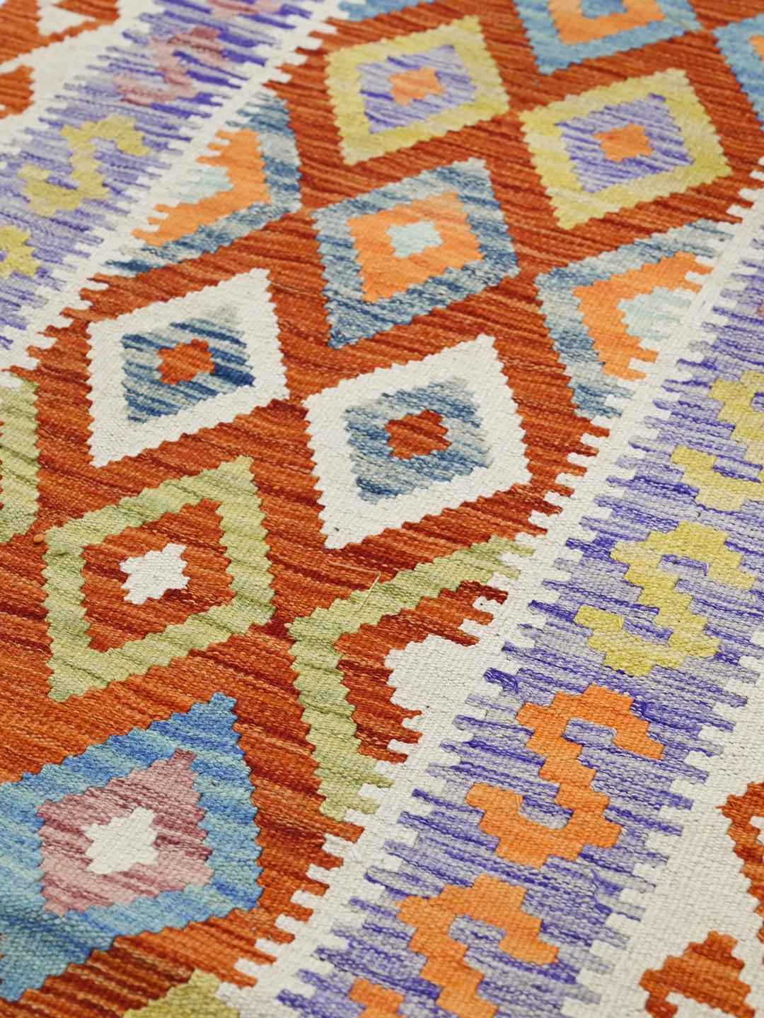 Hand-woven Afghan runner with red and blue geometric diamond patterns