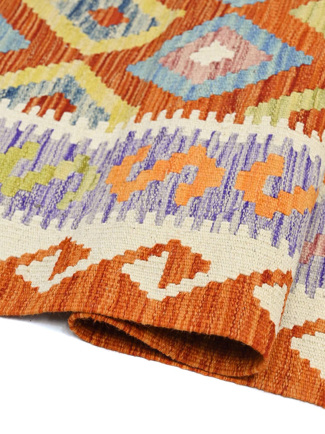 Hand-woven Afghan runner with red and blue geometric diamond patterns