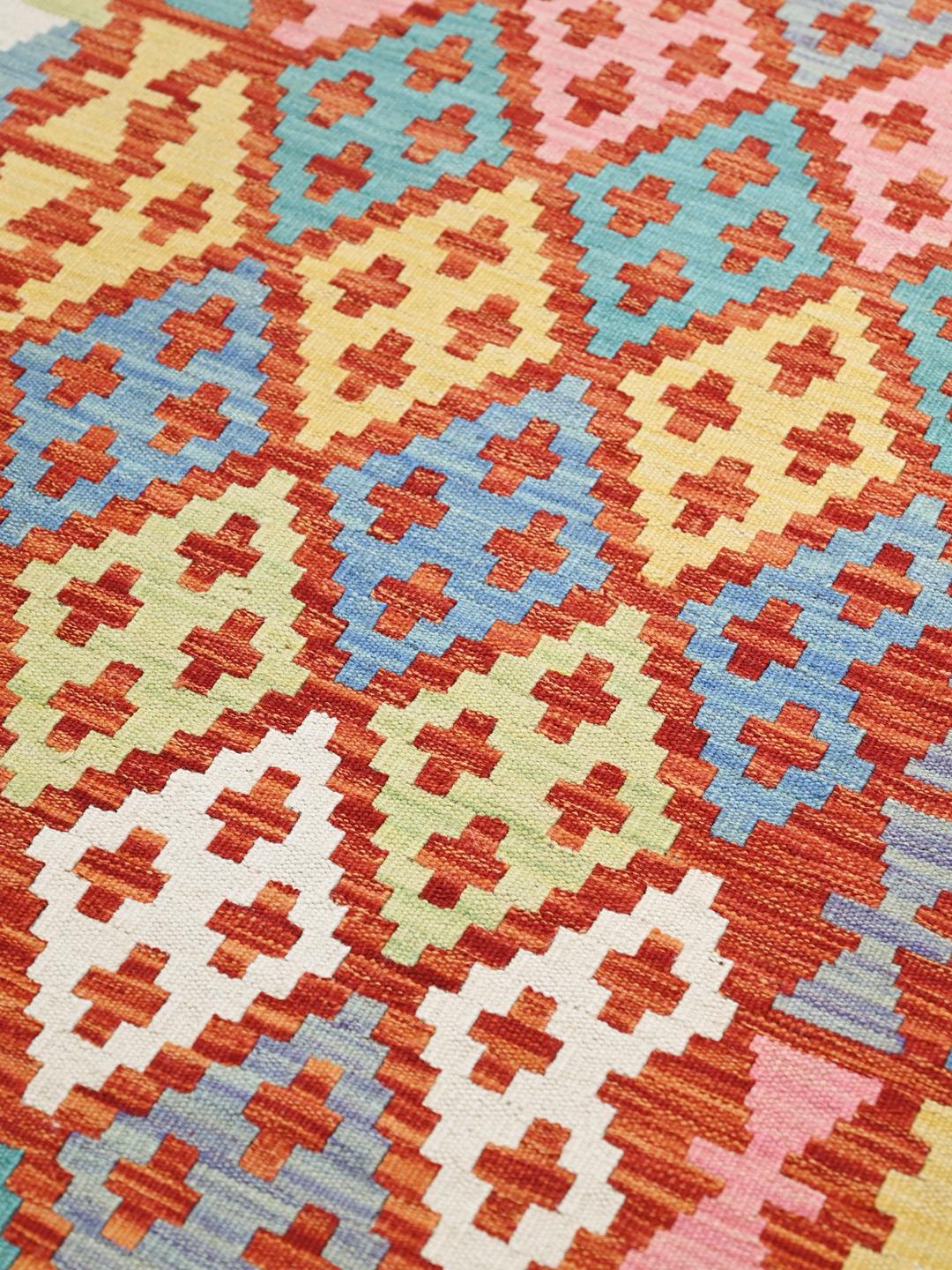 Hand-woven Afghan runner with a vibrant geometric pattern in multicolor wool