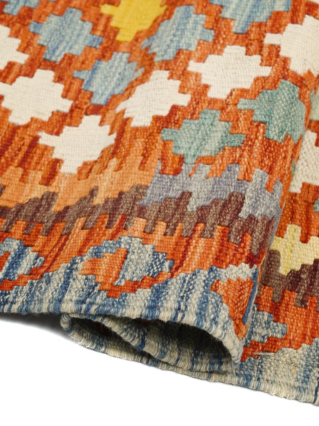 Hand-woven Afghan runner with a geometric diamond pattern in red, blue, and yellow Wool.