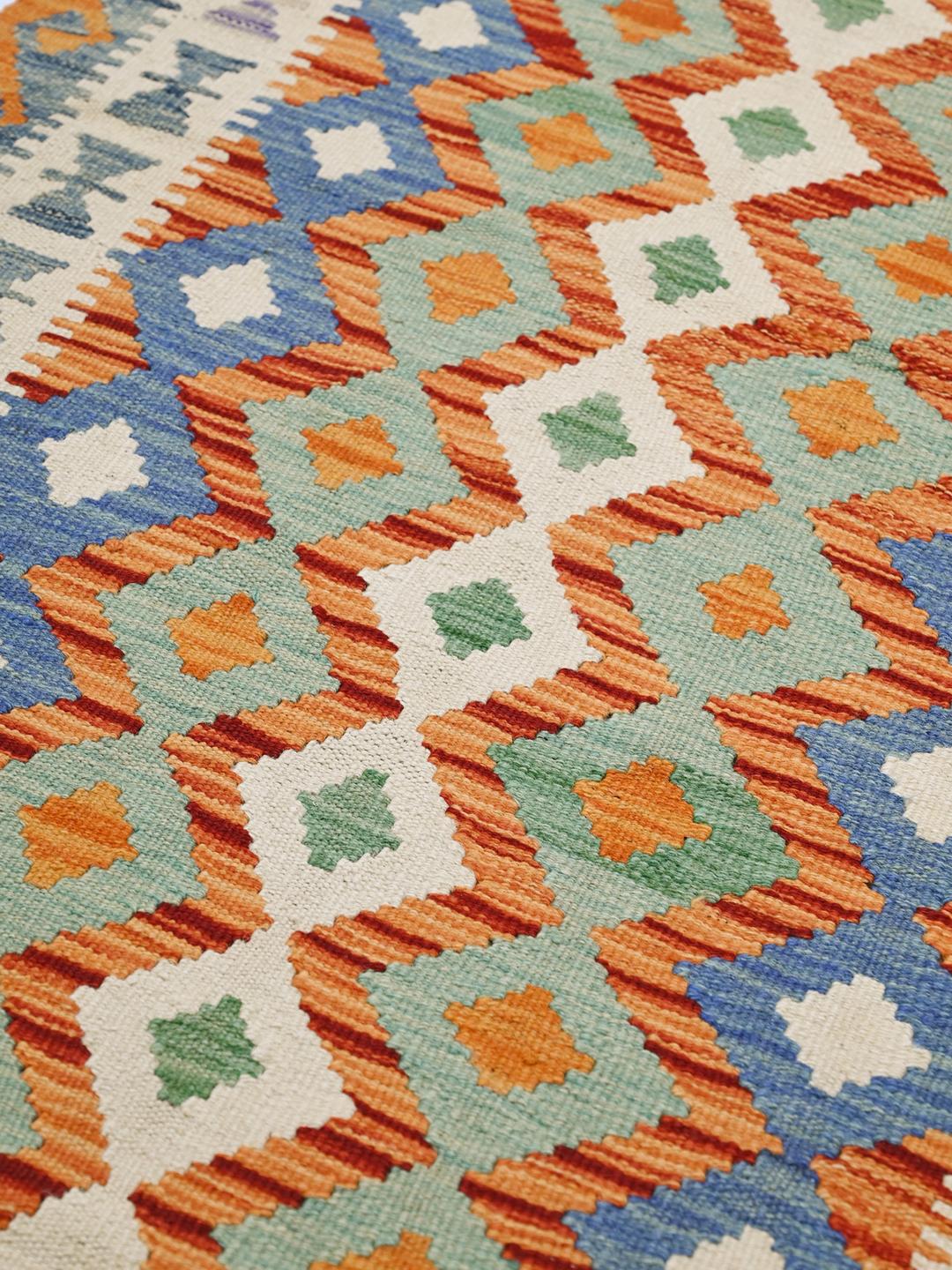 Hand-woven Afghan runner with vibrant multicolored diamond patterns