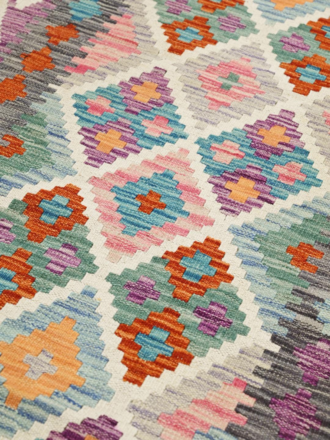 Hand-woven Afghan runner rug with a multicolor geometric diamond pattern