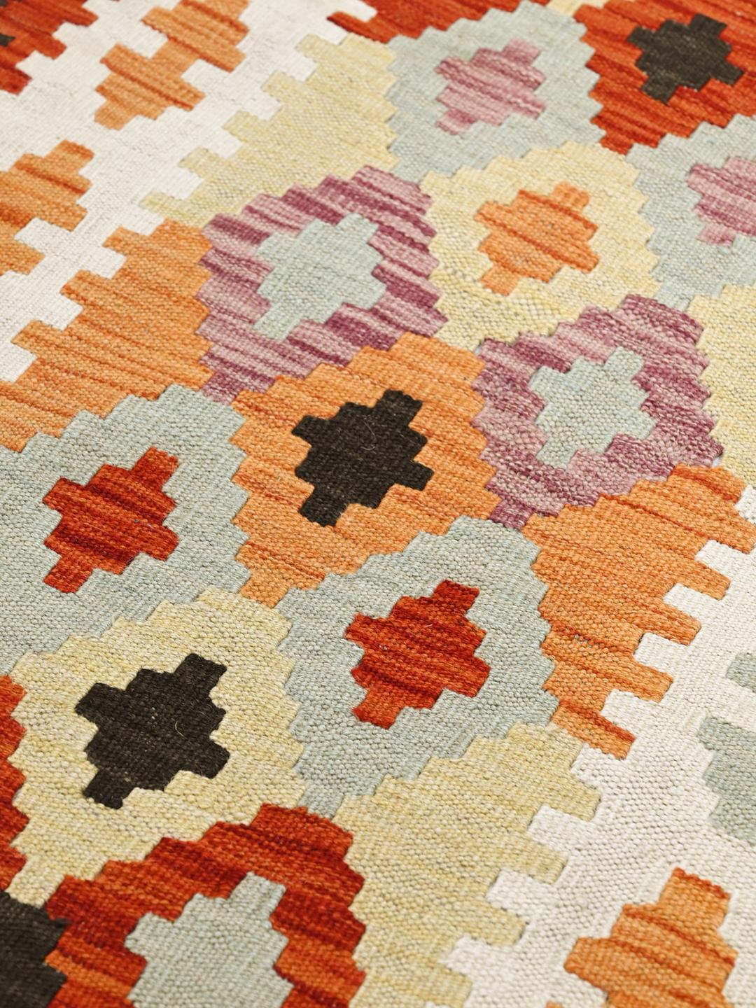 Hand-woven Afghan runner with vibrant geometric patterns and a multicolor palette.