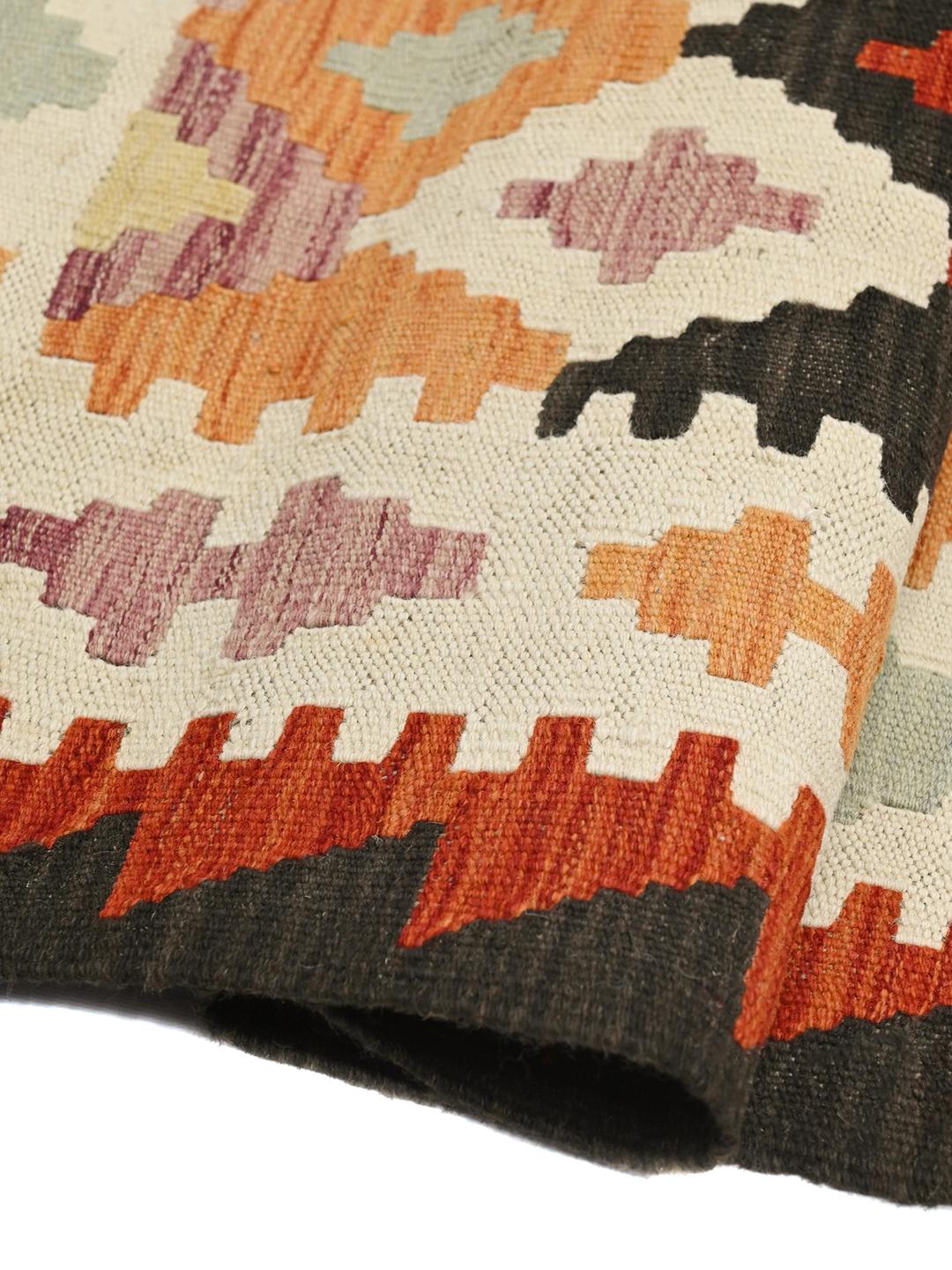 Hand-woven Afghan runner with vibrant geometric patterns and a multicolor palette.