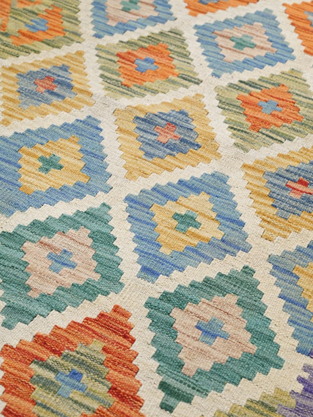 A vibrant, hand-woven Afghan runner rug with a geometric diamond pattern in multicolor Wool.
