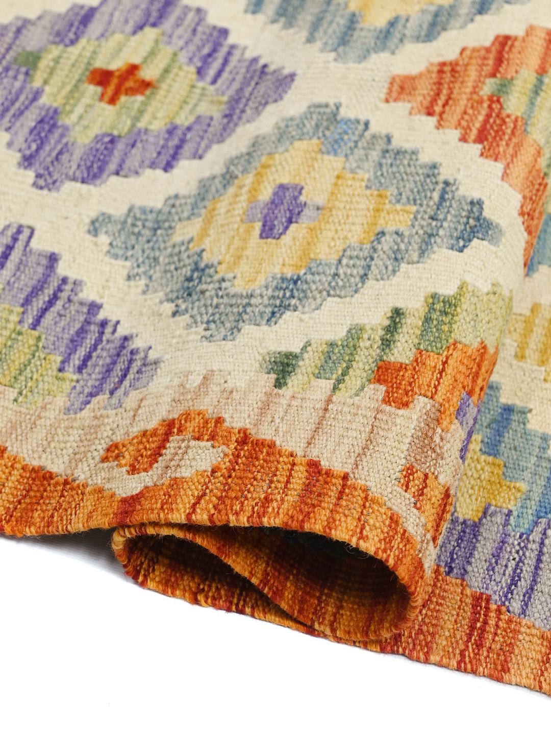 A vibrant, hand-woven Afghan runner rug with a geometric diamond pattern in multicolor Wool.