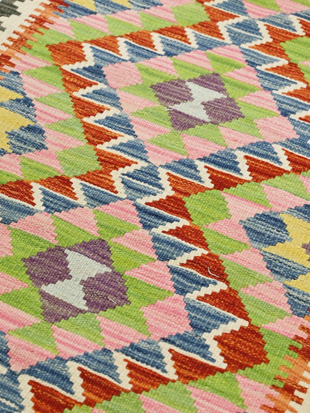 Hand-woven Afghan runner featuring vibrant geometric patterns in multicolor wool