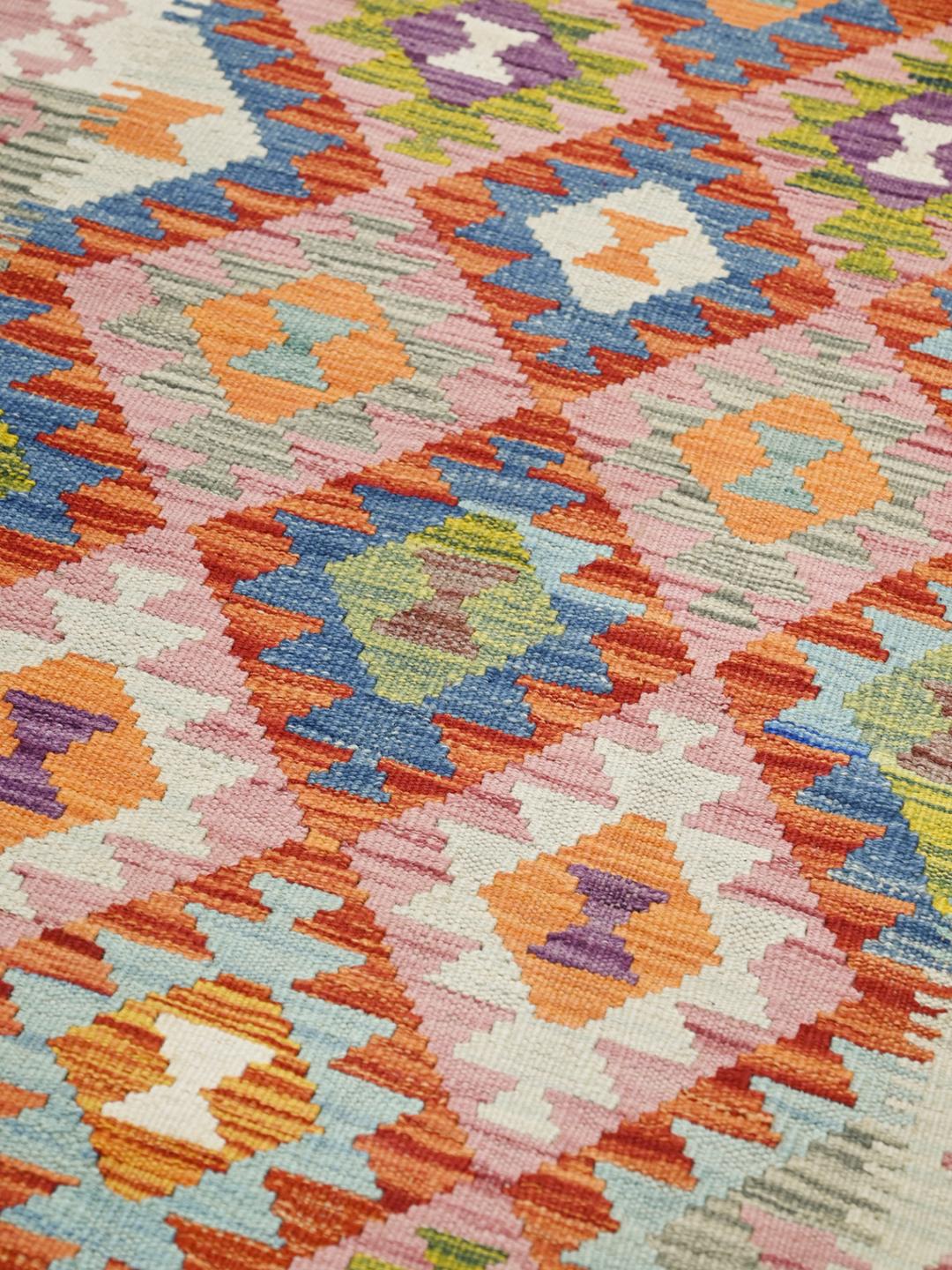 Hand-woven Afghan runner with a vibrant geometric diamond pattern in multicolor wool