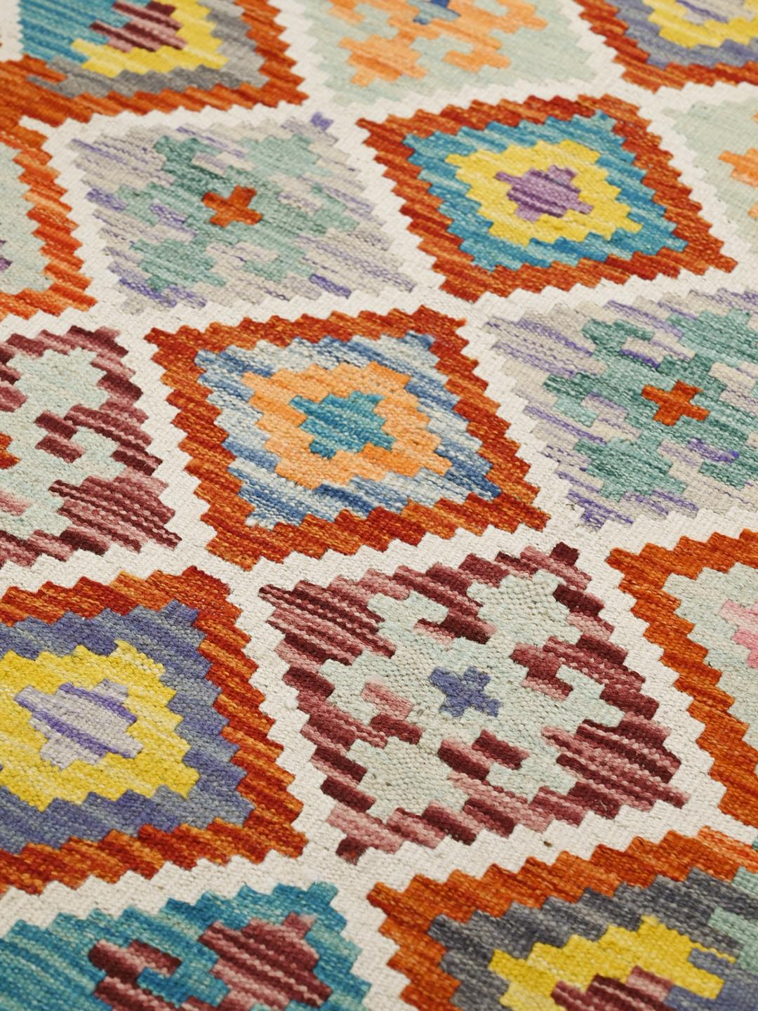 Hand-woven Afghan runner with a vibrant geometric diamond pattern in multicolor