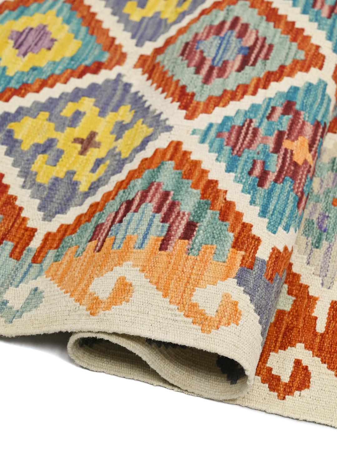 Hand-woven Afghan runner with a vibrant geometric diamond pattern in multicolor