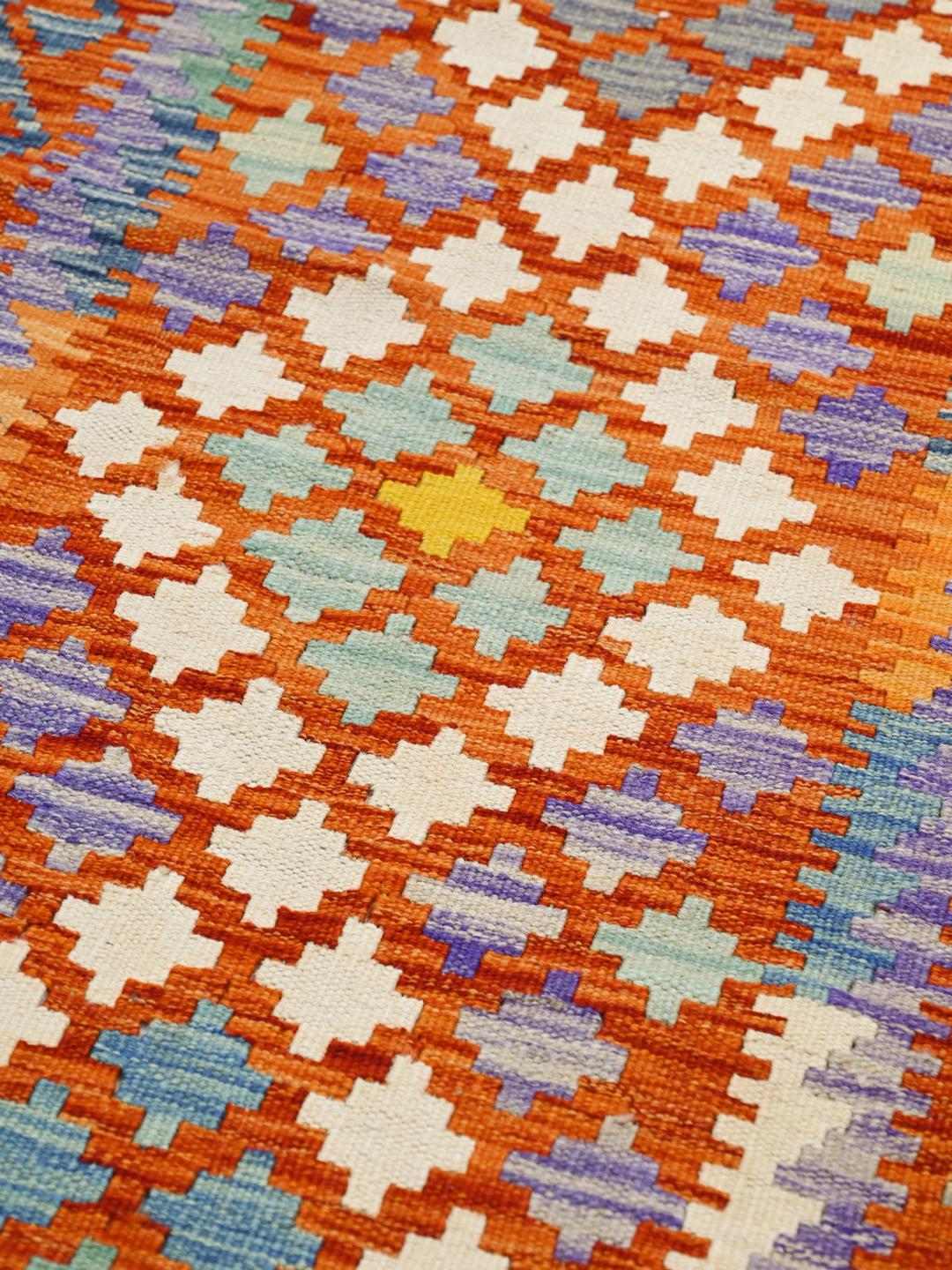 Hand-woven Afghan runner with colourful geometric patterns in multicolour wool