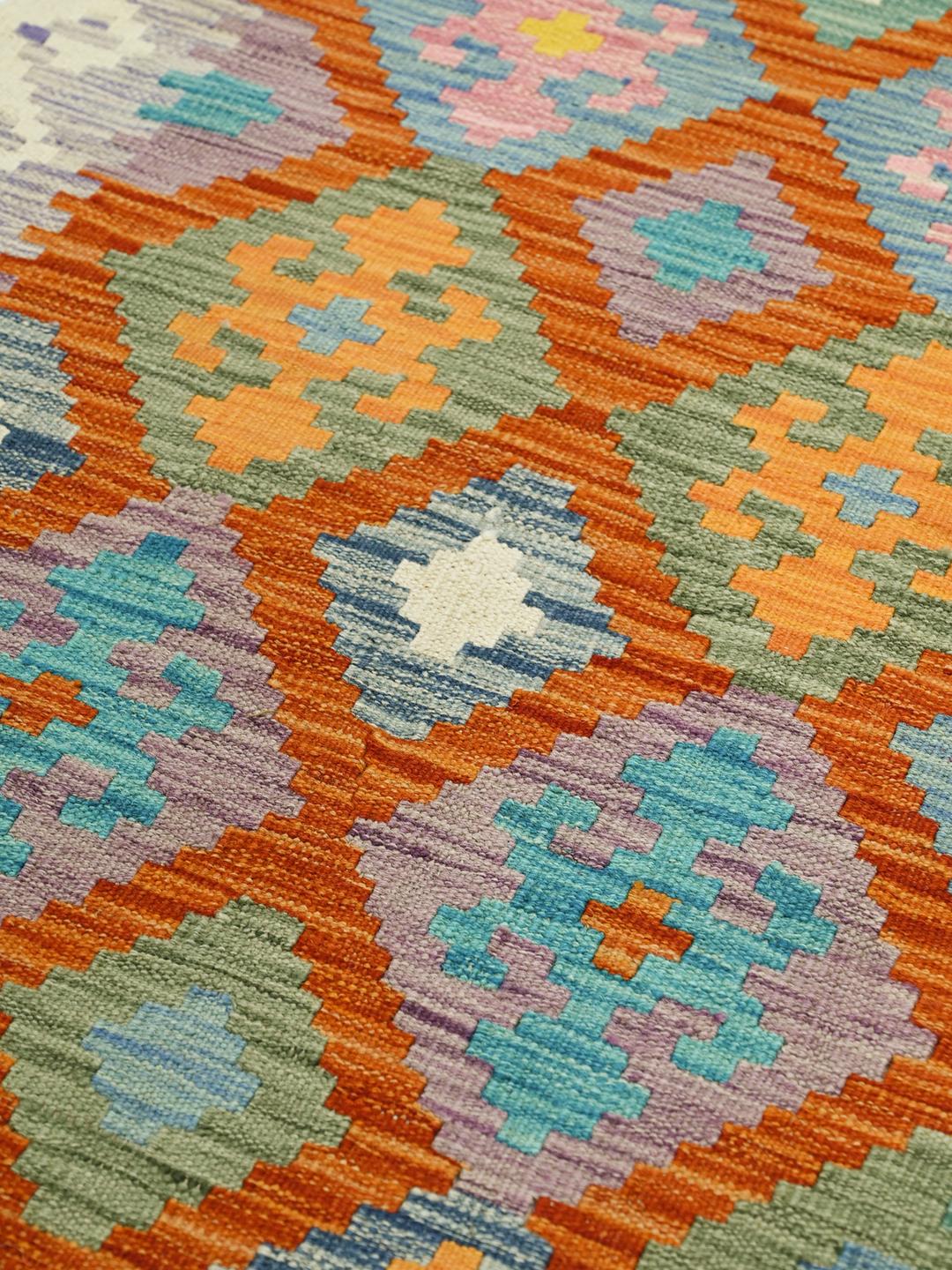 Hand-woven Afghan runner with colourful geometric diamond patterns