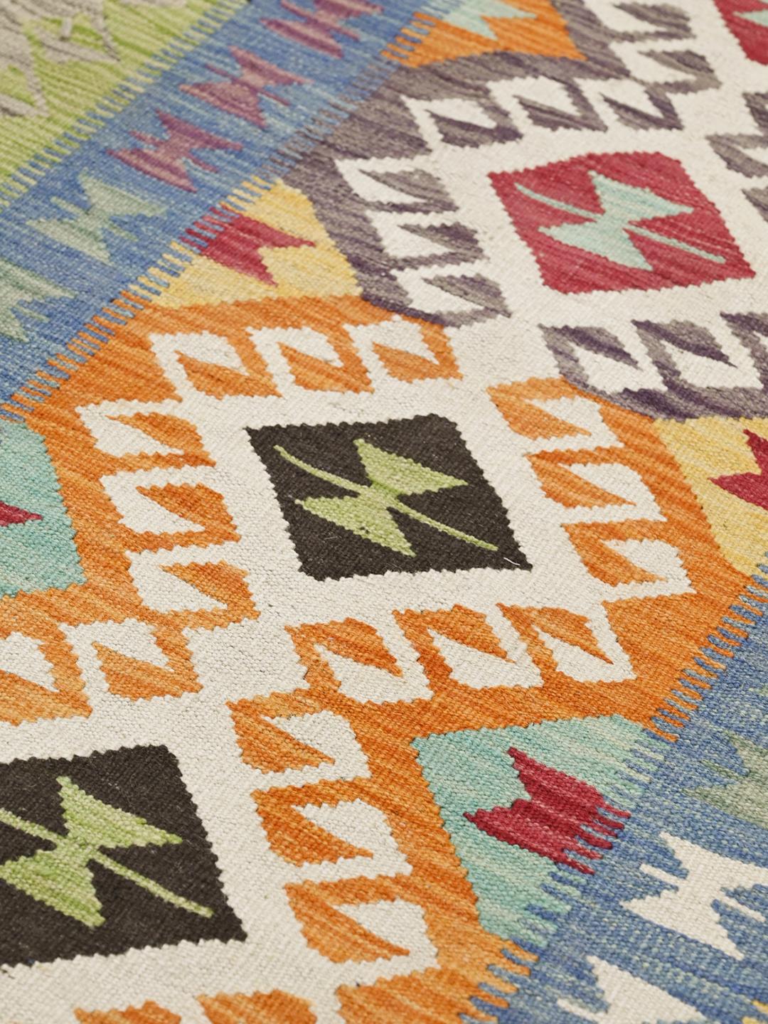 Hand-woven Afghan runner with vibrant geometric patterns in multicolor wool