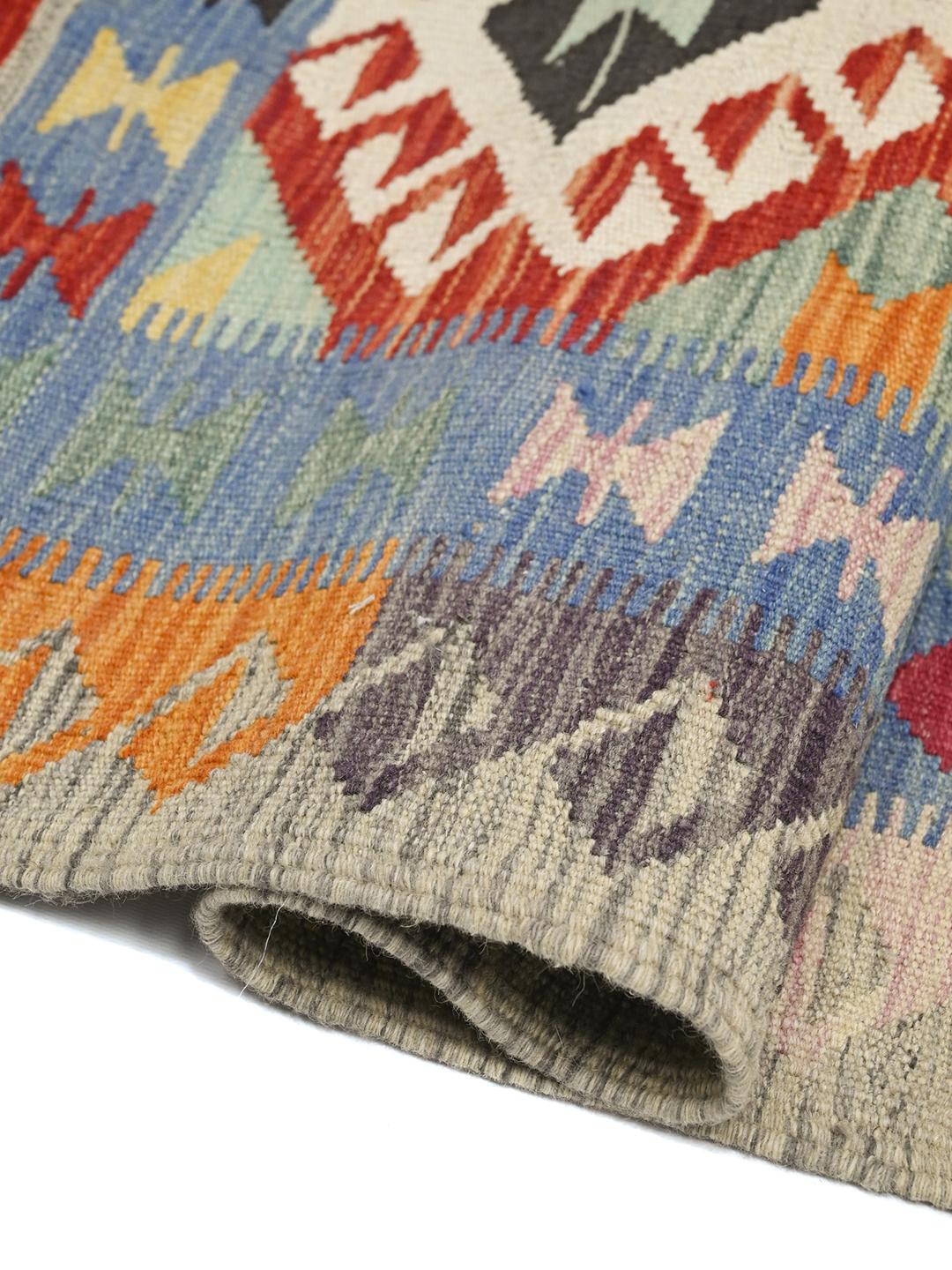 Hand-woven Afghan runner with vibrant geometric patterns in multicolor wool