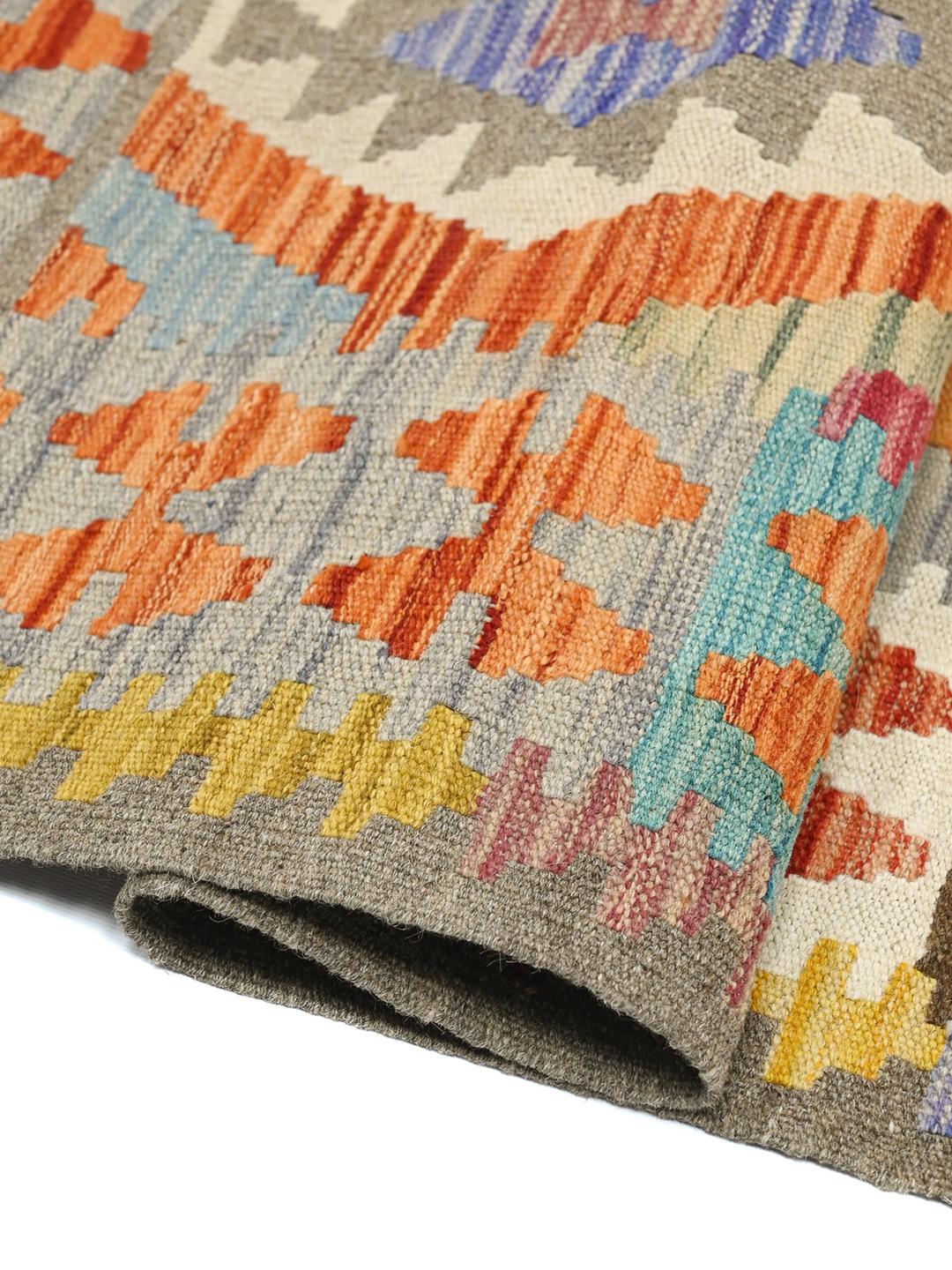 Hand-woven Afghan Kelim rug featuring geometric patterns in multicolour wool