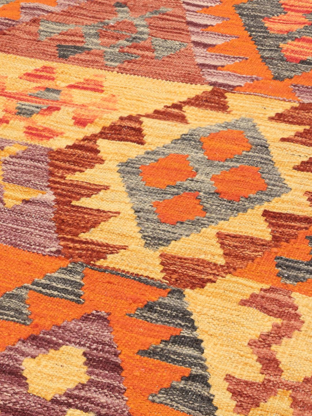 Tapis Kelim afghan tissé à la main arborant un motif géométrique multicolore en losanges