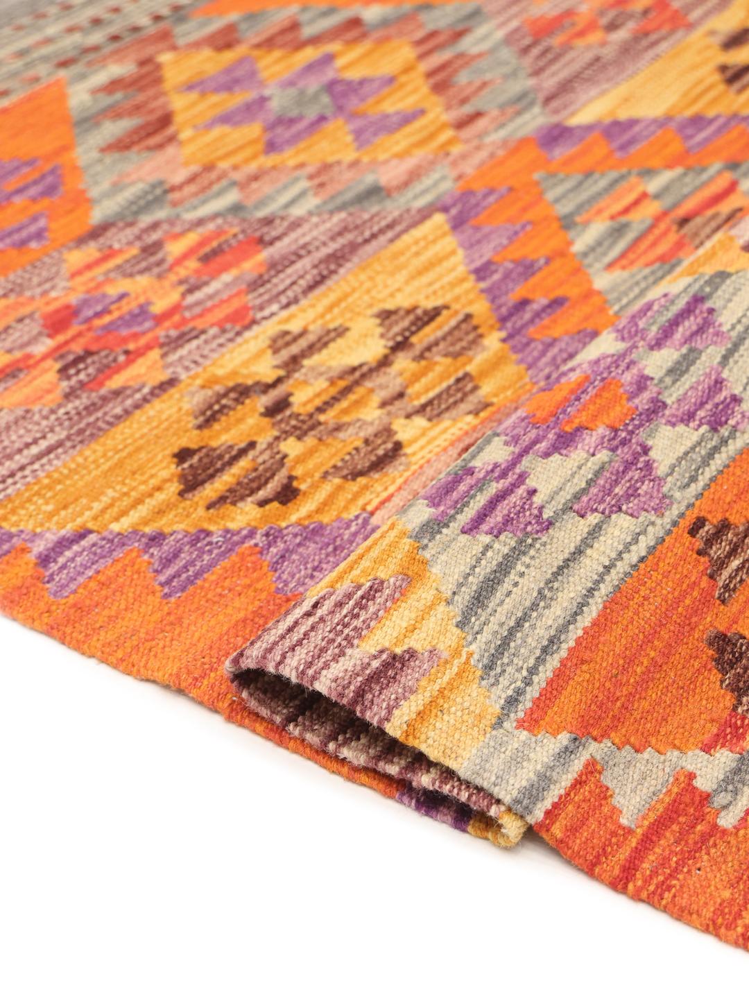 Hand-woven Afghan Kelim rug featuring vibrant geometric patterns in multicolor wool.