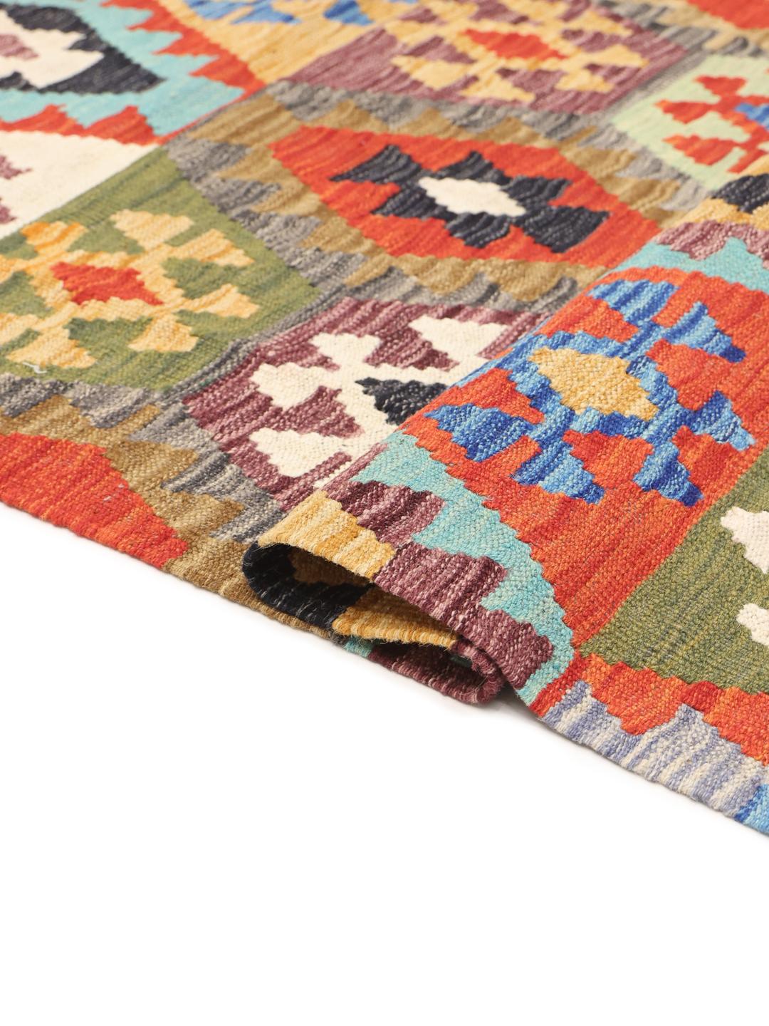 A long, rectangular Afghan runner featuring a vibrant, multi-coloured geometric pattern.