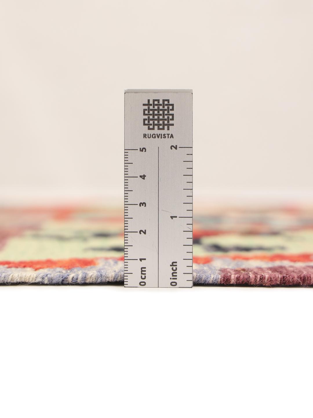 A long, rectangular Afghan runner featuring a vibrant, multi-coloured geometric pattern.
