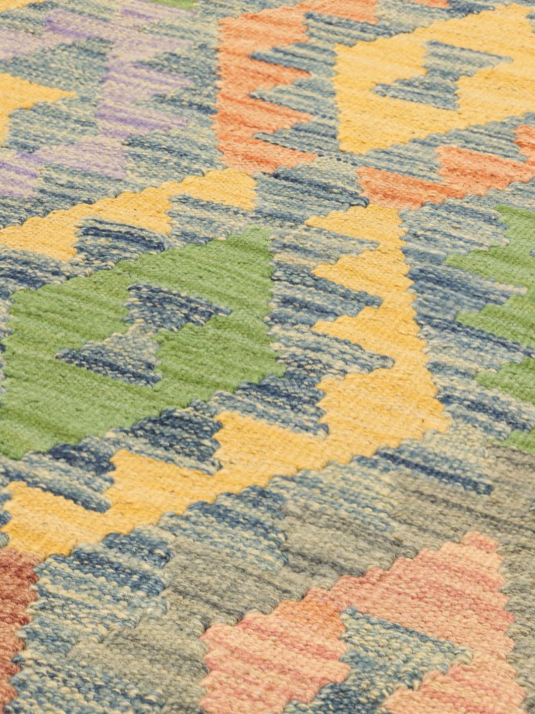 Hand-woven Afghan Kelim rug featuring a colourful geometric diamond pattern