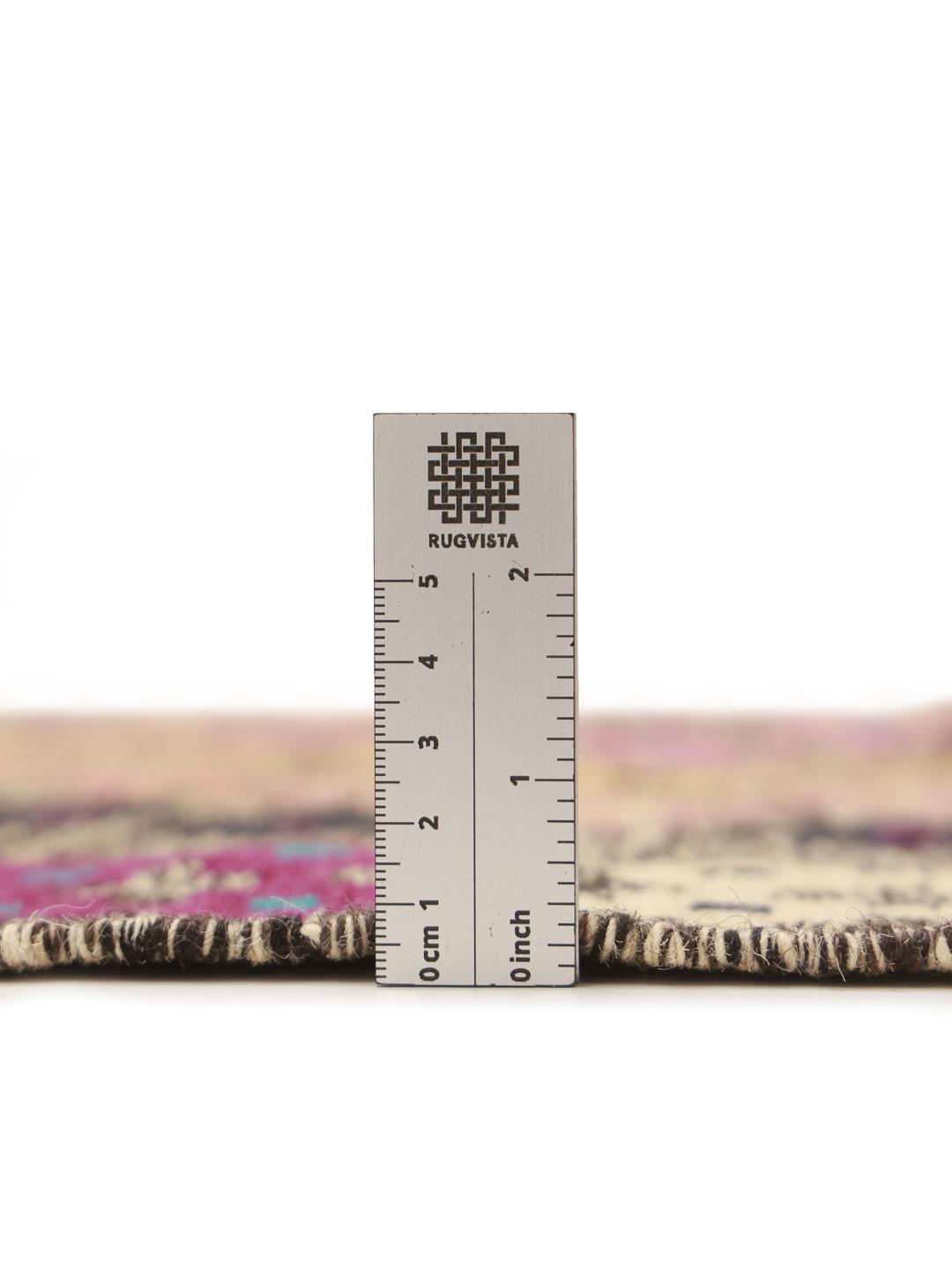 Hand-woven Afghan runner with colourful geometric patterns on a grey background